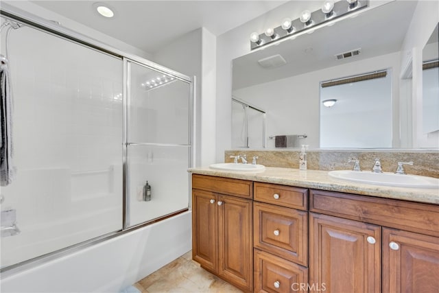 bathroom featuring vanity and combined bath / shower with glass door