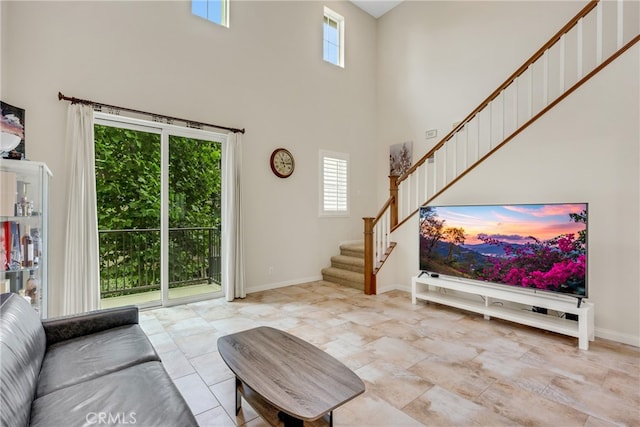 living room featuring a healthy amount of sunlight and a high ceiling