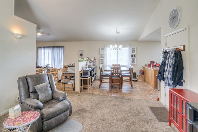 carpeted living room with lofted ceiling and ceiling fan with notable chandelier