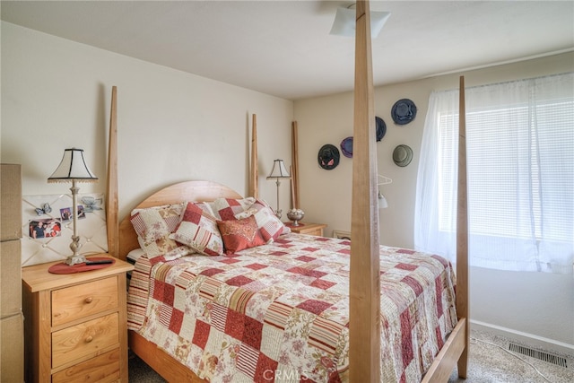 carpeted bedroom with multiple windows