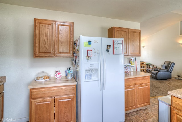 kitchen with white fridge with ice dispenser