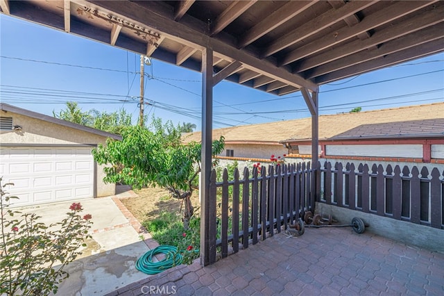 view of patio / terrace featuring a garage