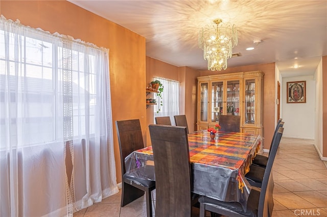 tiled dining space with an inviting chandelier