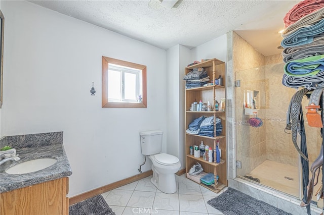 bathroom featuring a shower with door, toilet, tile patterned flooring, vanity, and a textured ceiling