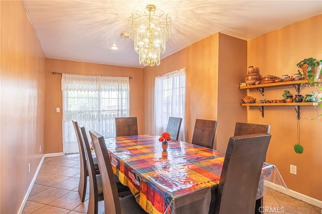 dining space with a notable chandelier and light tile patterned flooring