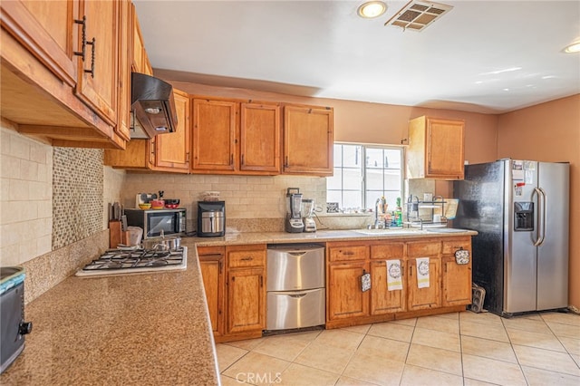 kitchen featuring light tile patterned floors, stainless steel appliances, sink, and premium range hood