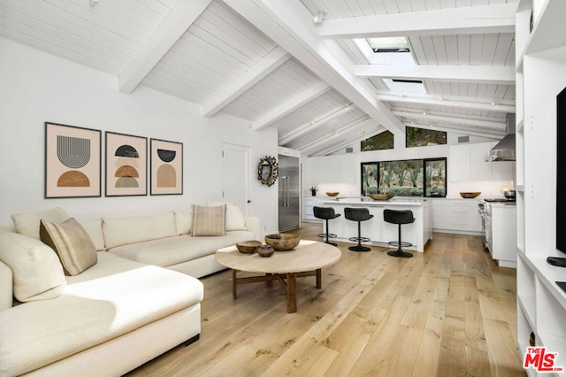 living room with lofted ceiling with skylight, light hardwood / wood-style flooring, and wooden ceiling