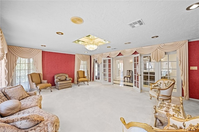 living area with light carpet, a textured ceiling, and french doors