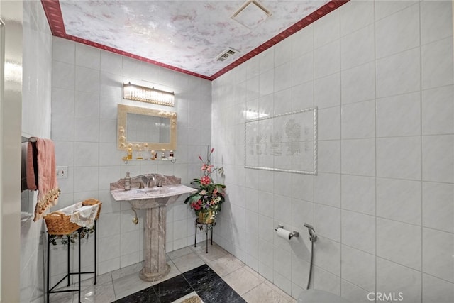 bathroom with tile walls