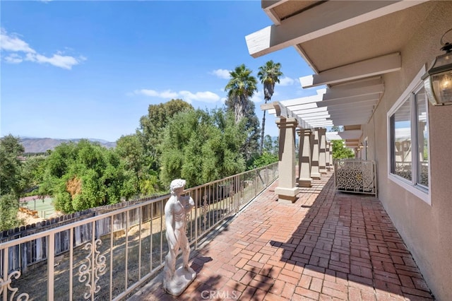 balcony featuring a pergola and a mountain view