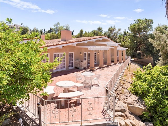 back of house with french doors, a pergola, and a patio area