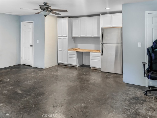 garage featuring ceiling fan and stainless steel refrigerator