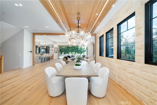 dining space with wood-type flooring and a chandelier