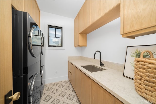 kitchen featuring light brown cabinets, sink, and light tile flooring