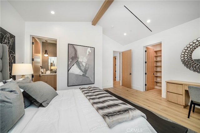 bedroom featuring a closet, a walk in closet, vaulted ceiling with beams, ensuite bathroom, and hardwood / wood-style flooring