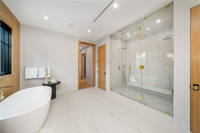 bathroom featuring tile flooring and separate shower and tub