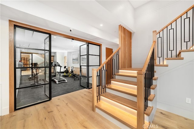 staircase with light hardwood / wood-style floors