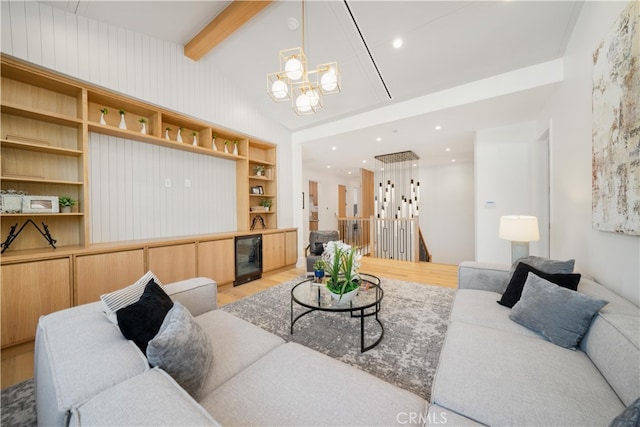 living room with a chandelier, hardwood / wood-style flooring, lofted ceiling with beams, and wine cooler