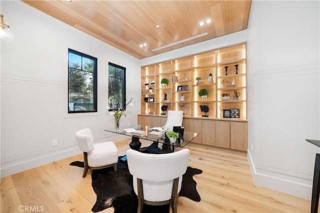 office area with built in features, wood ceiling, and light wood-type flooring