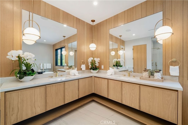 bathroom featuring tile floors, wooden walls, and dual vanity