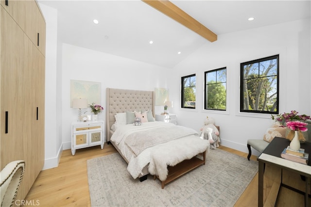 bedroom featuring lofted ceiling with beams and light wood-type flooring