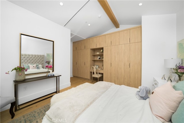 bedroom with lofted ceiling with beams and light wood-type flooring