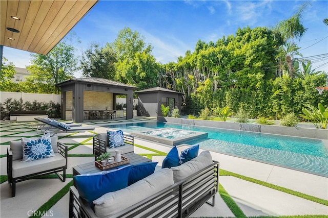 view of swimming pool with outdoor lounge area, a patio, and an outdoor structure