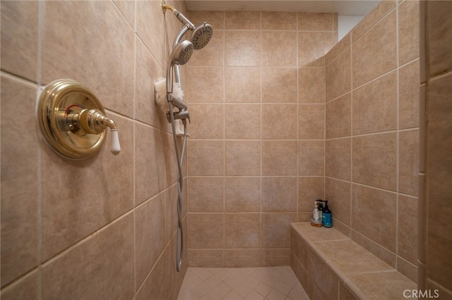 bathroom featuring tile patterned flooring and tiled shower