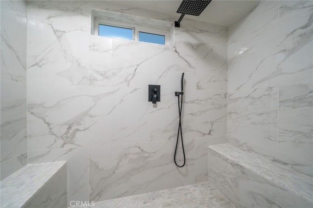 bathroom with tiled shower