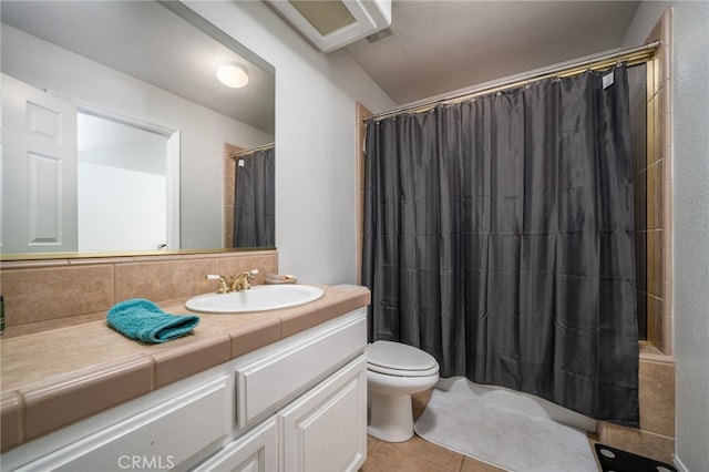 bathroom with tile patterned flooring, vanity, toilet, and a shower with curtain