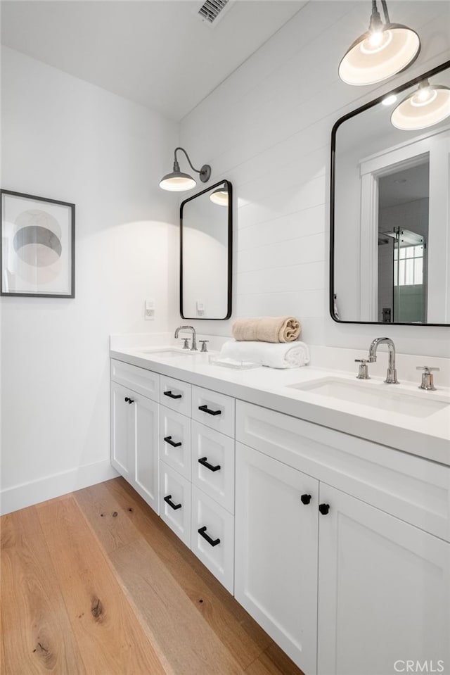 bathroom featuring vanity and hardwood / wood-style floors