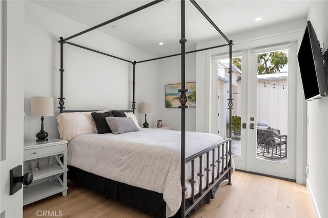 bedroom featuring light wood-type flooring and access to exterior