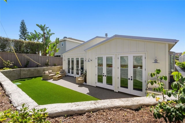 rear view of property featuring french doors and a patio area