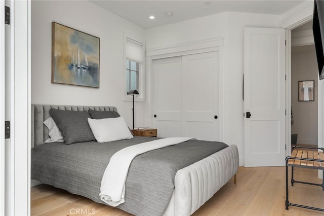 bedroom with a closet and light wood-type flooring