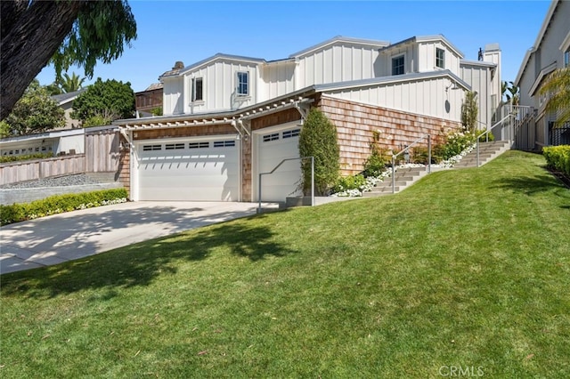 view of front of property with a front yard and a garage