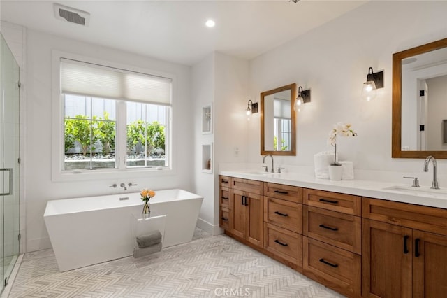 bathroom featuring vanity and separate shower and tub