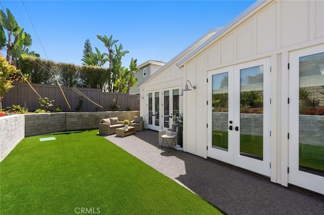 view of yard featuring french doors, a patio area, and outdoor lounge area