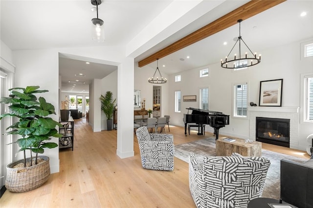 living room with light hardwood / wood-style flooring and lofted ceiling with beams