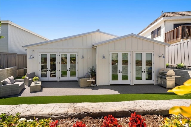 back of property with french doors, a patio, and outdoor lounge area