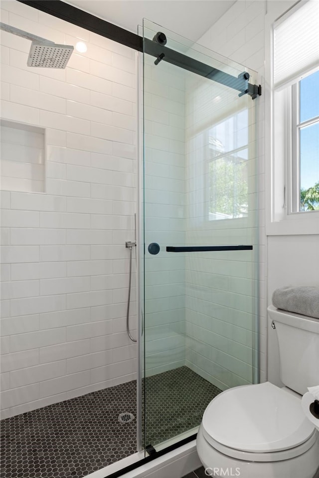 bathroom with toilet and walk in shower