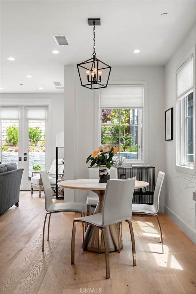 dining room featuring a notable chandelier and light wood-type flooring