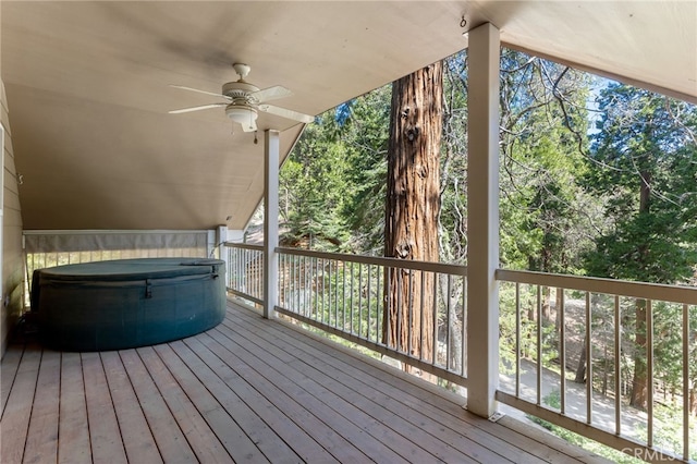 wooden terrace featuring a hot tub and ceiling fan