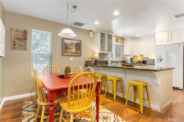 dining space with wood-type flooring and sink