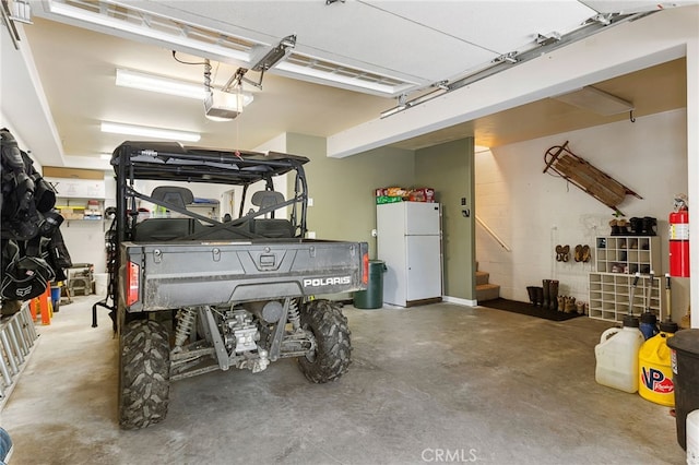 garage featuring a garage door opener and white fridge