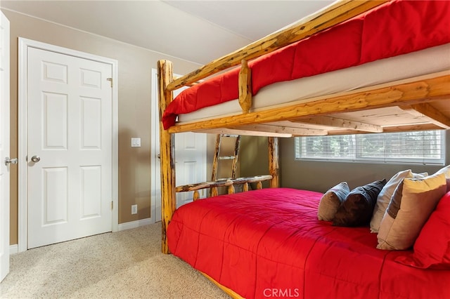 bedroom with carpet flooring and beamed ceiling