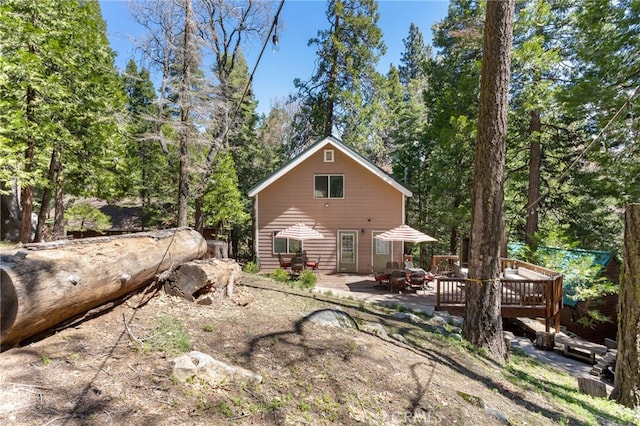 back of property with a wooden deck