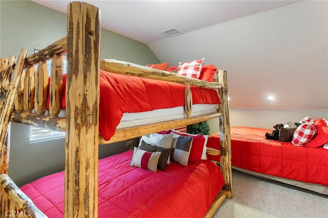 carpeted bedroom with lofted ceiling