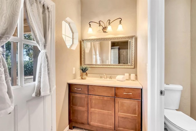 bathroom with toilet and vanity