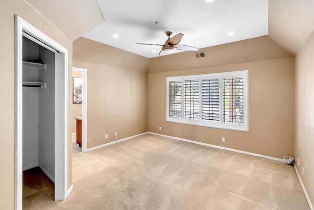 unfurnished bedroom featuring light colored carpet, baseboards, visible vents, and a closet