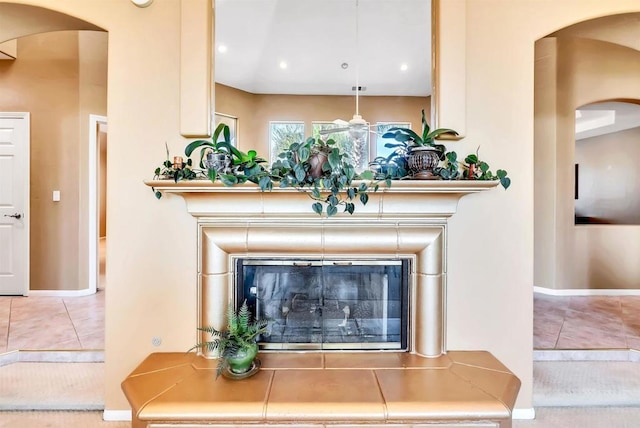 room details with baseboards, arched walkways, and recessed lighting